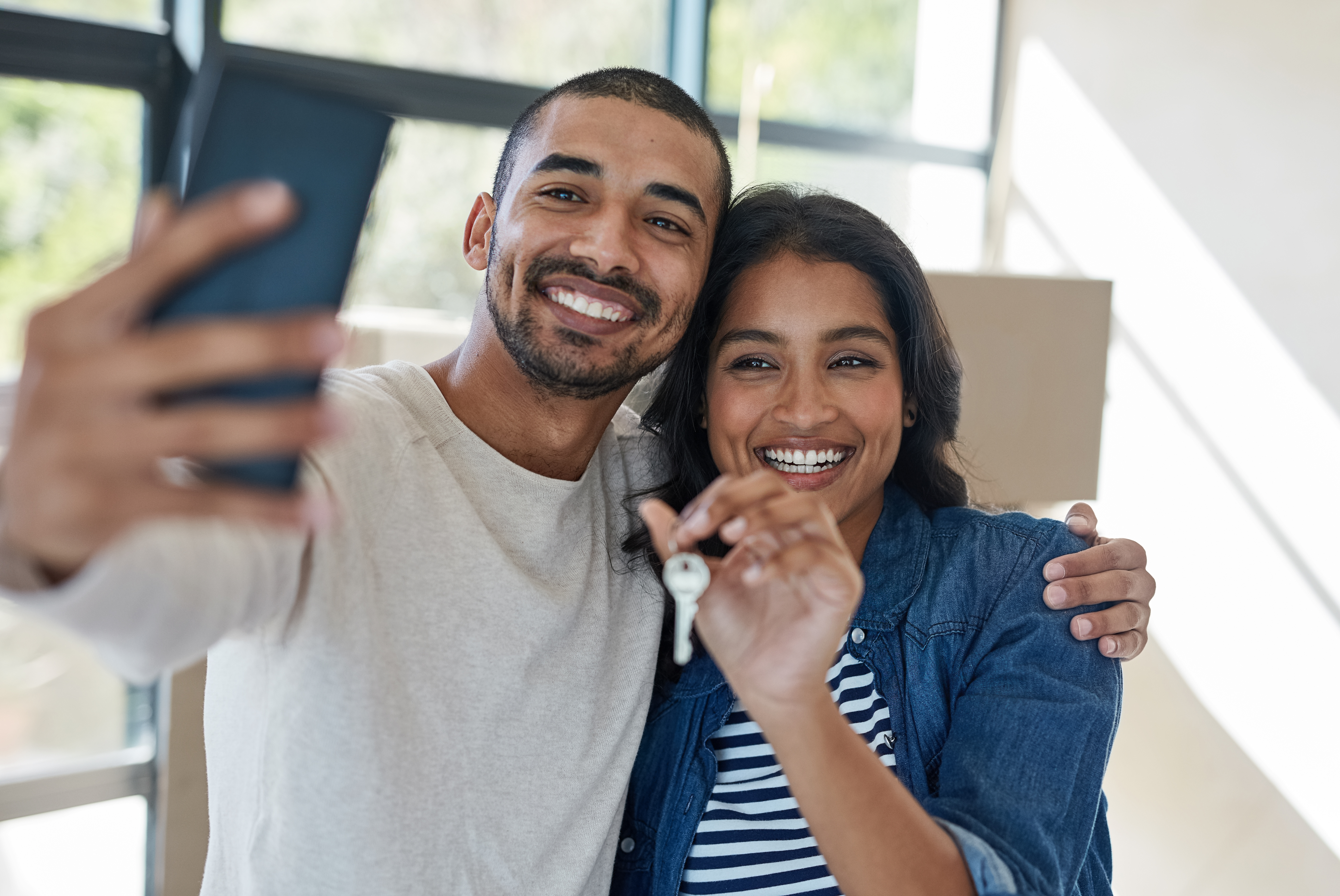 Couple holding key taking a selfie