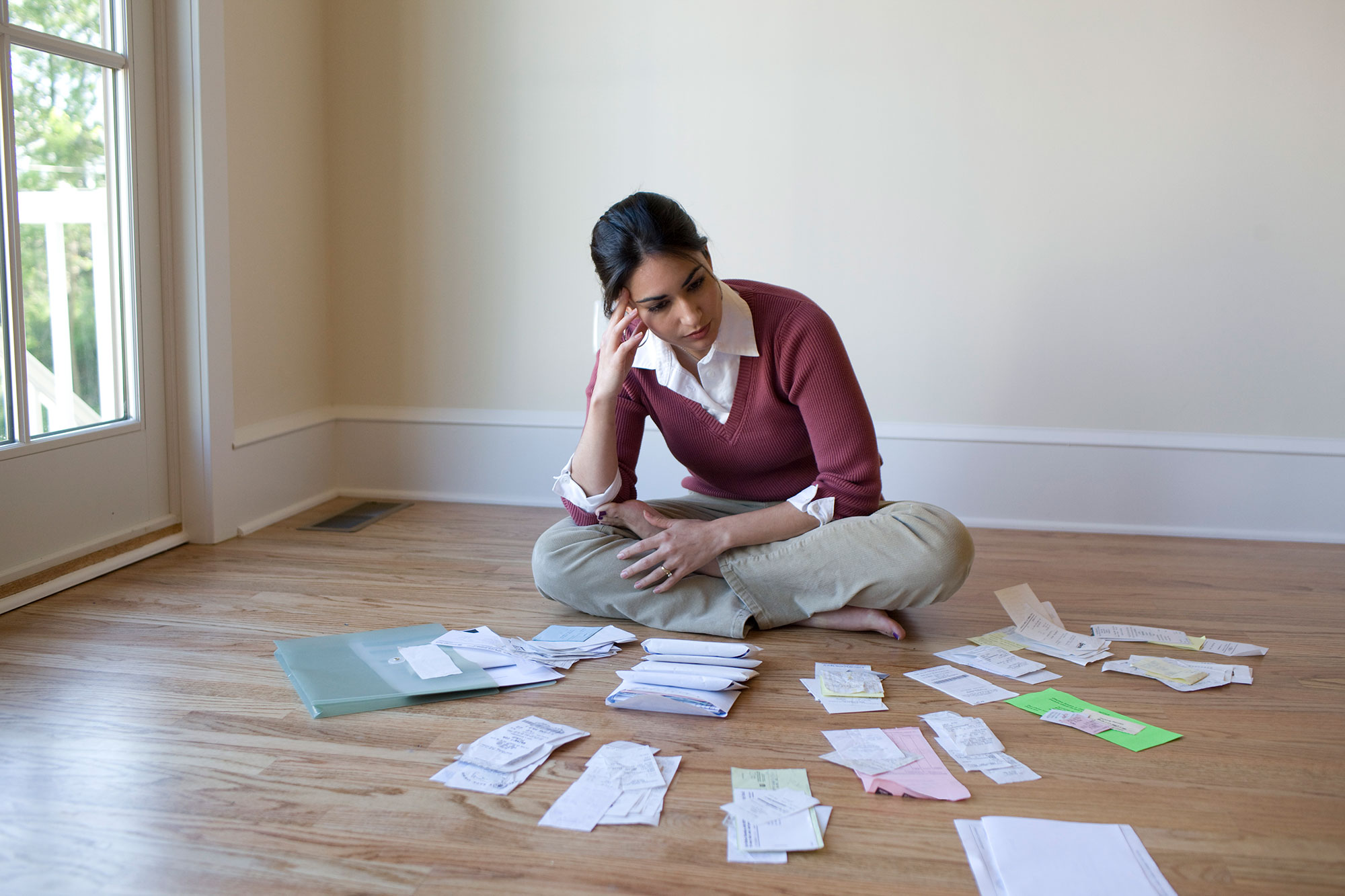 Woman looking at bills on floor