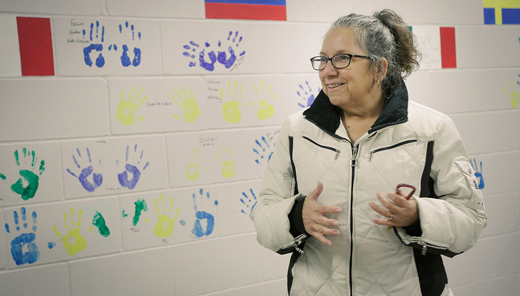 Woman_in_front_of_wall_with_handprints